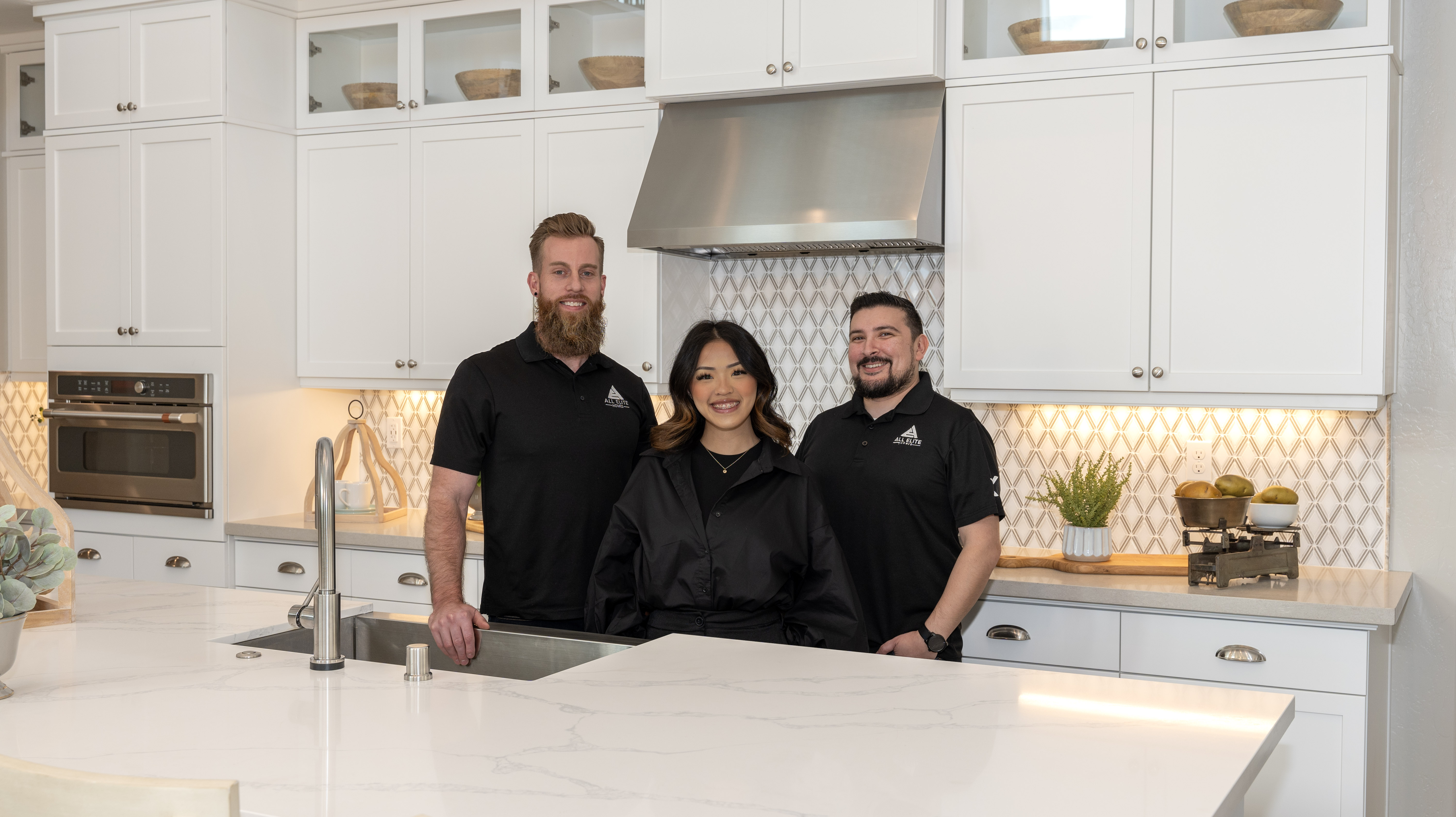 The All Elite Homes team smiling in a kitchen